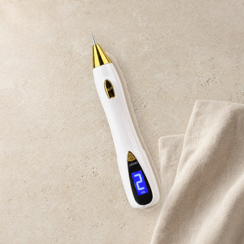 The Ameleria plasma pen on a stone surface beside a linen towel, screen set to level two